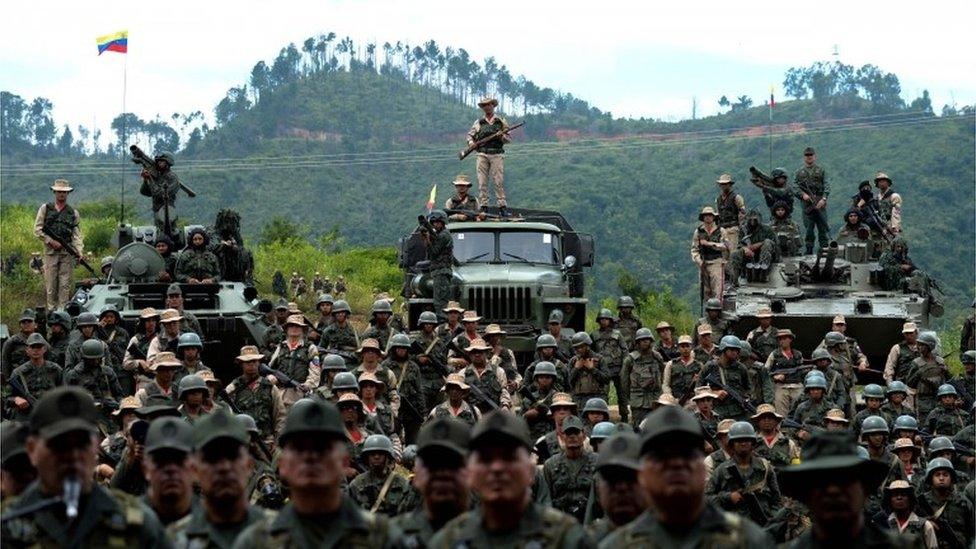 Venezuelan troops in different fatigues and carrying various weapons attend the press conference given by Defence Minister general Vladimir Padrino Lopez at Fort Tiuna in Caracas on August 14, 2017.