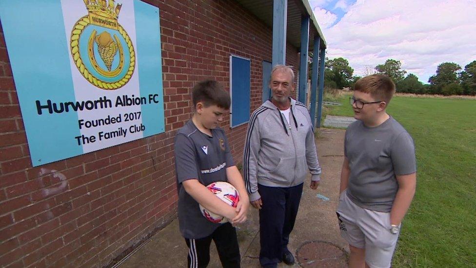 Robbie and Logan with their uncle Shane at the football club