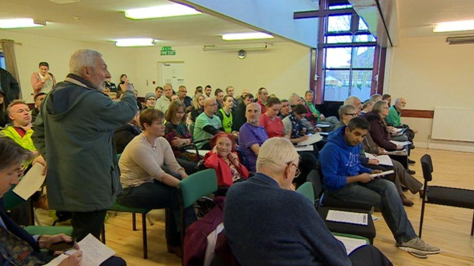 A man addresses the meeting