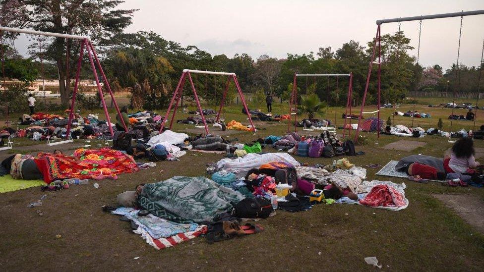 migrants sleep in a schoolyard on their way to the US