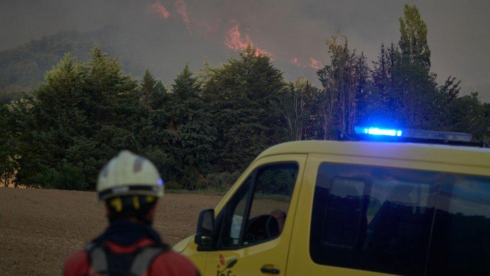 A firefighter arriving to the scene of a wildfire in Navarra, Spain.