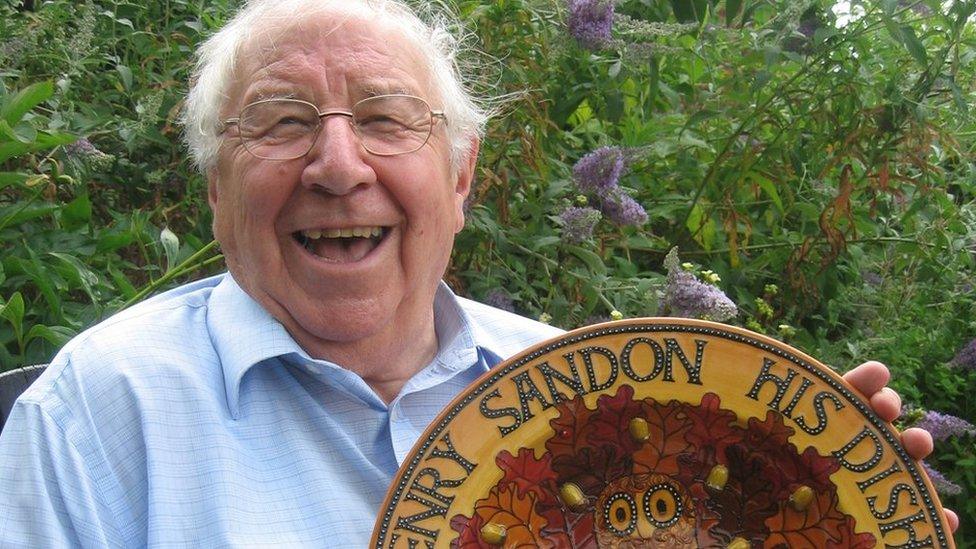 Henry with a pottery plate bearing his name