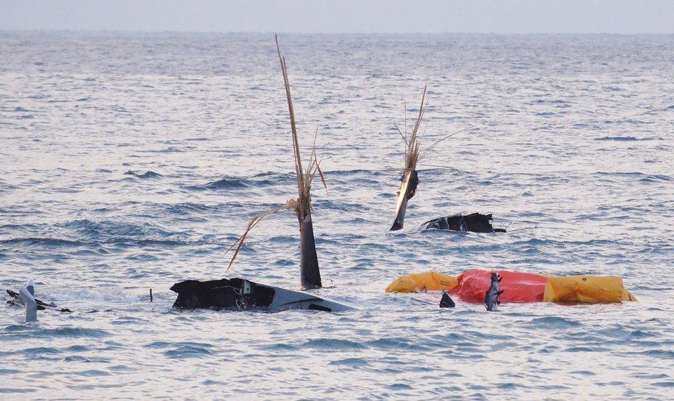 Sheared-off rotor blades of a US Marine MV-22 Osprey tilt-rotor aircraft are seen sticking out of the water on the coast of Nago, Japan's southern island of Okinawa on 14 December 2016, after the aircraft crash landed in shallow waters late 13 December.