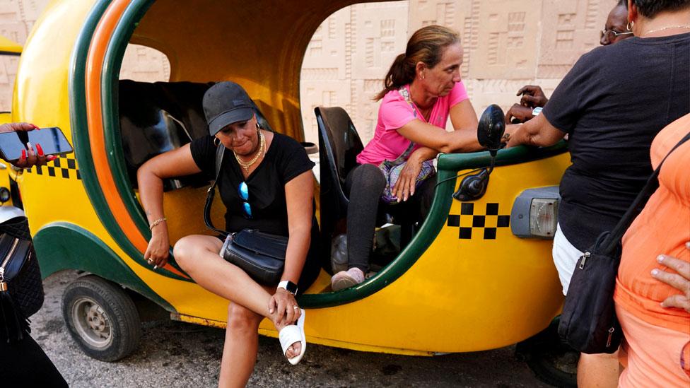 Taxi drivers wait in line to fill fuel at a petrol station in Havana, Cuba, on 25 April 2023