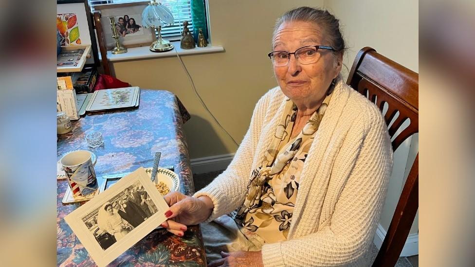 Margaret Lawes with old wedding photo