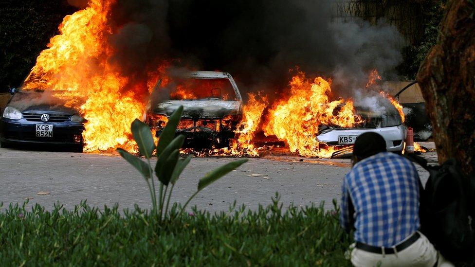 Cars are seen on fire in Nairobi, Kenya