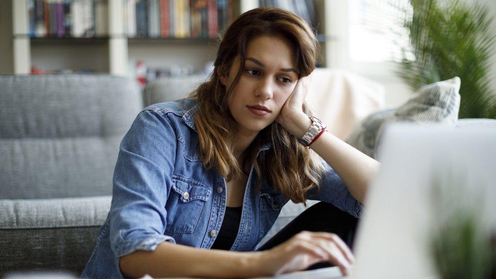 Woman at home looking at laptop