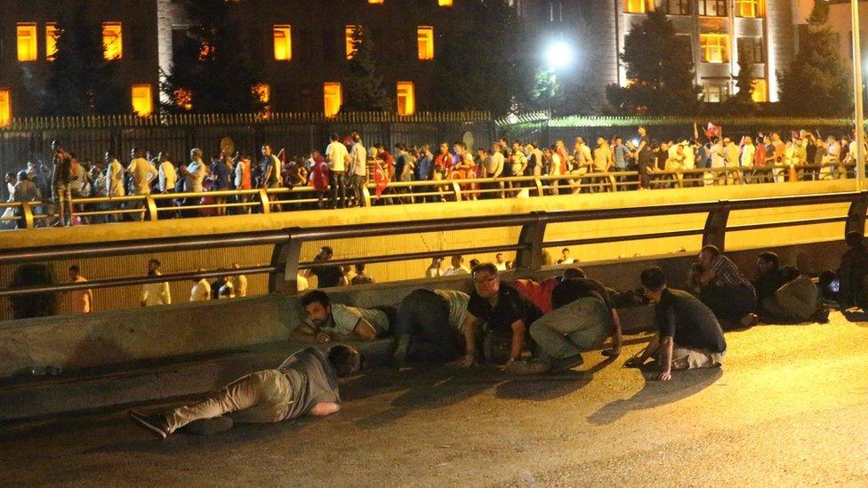 People in Ankara taking cover from gunfire