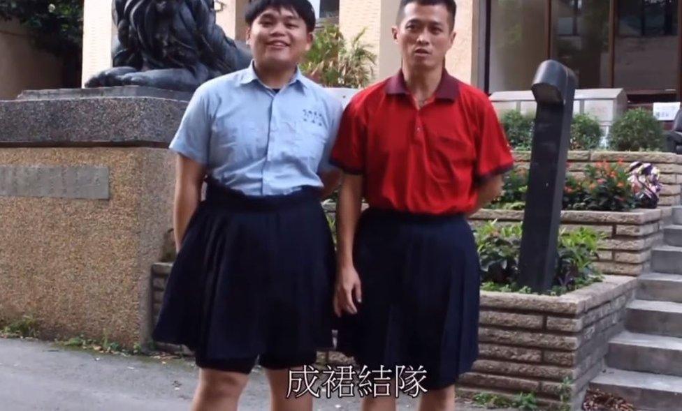 Male student and teacher wearing blue skirts