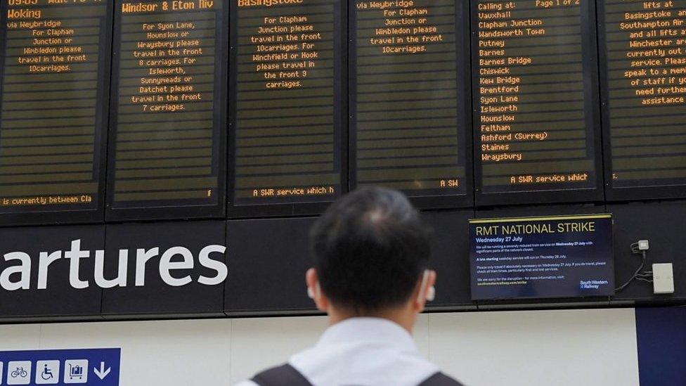 Man stares at rail station departure boards