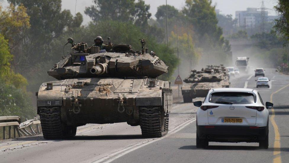 An Israeli tank heads for the border with Gaza