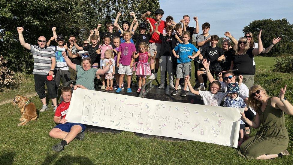 Local children and parents at the current bike track site