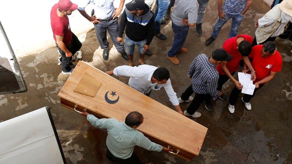 Relatives carry a coffin containing the body of an immigrant who drowned when a boat sank, at a hospital morgue in Sfax, Tunisia, on 4 June 2018