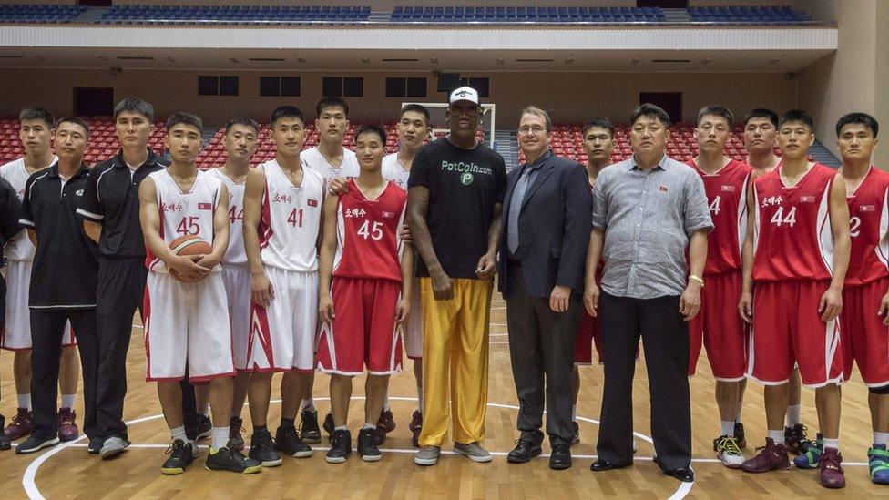 Former NBA star Dennis Rodman (C) of the US poses with North Korean basketball players at the Pyongyang Indoor Stadium on June 15, 201