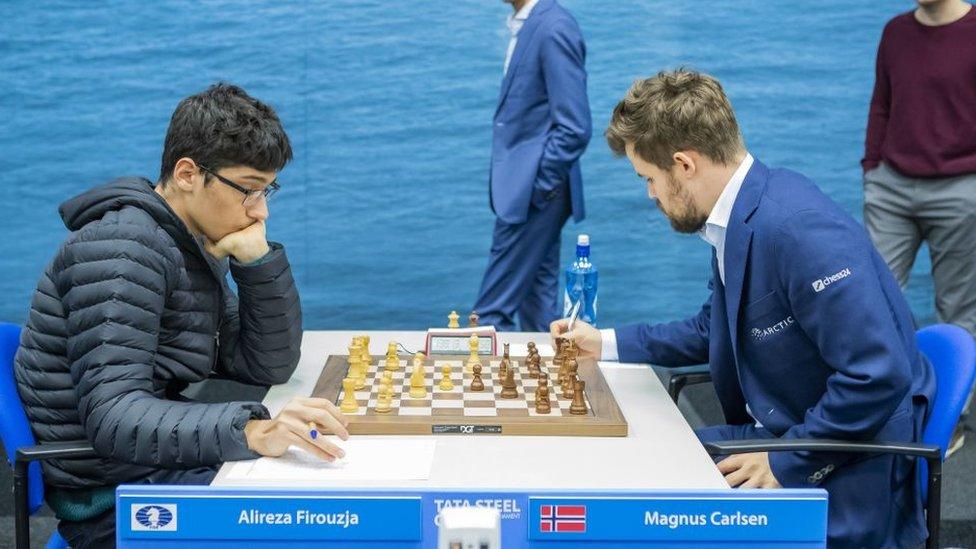 Alireza Firouzia plays chess with the current World Champion Magnus Carlsen