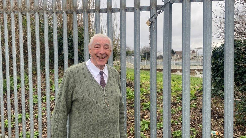 Michael Read, in front of Broomhill Lido, wearing a green cardigan and a tie