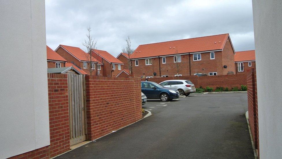 houses, cars in a car park