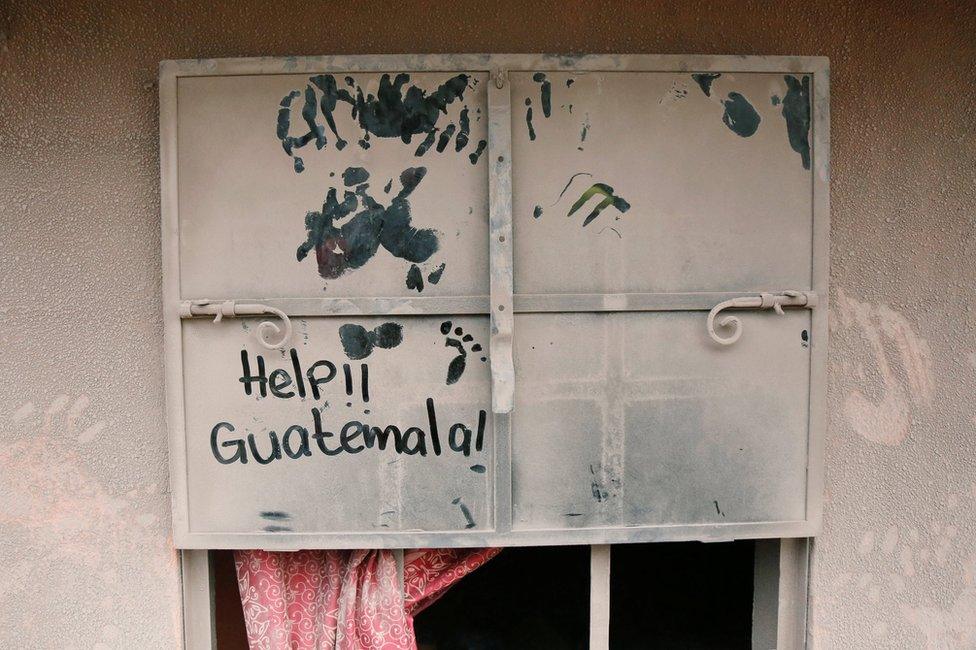 A sign on a widow covered with ash is seen at an area affected by the eruption of the Fuego volcano