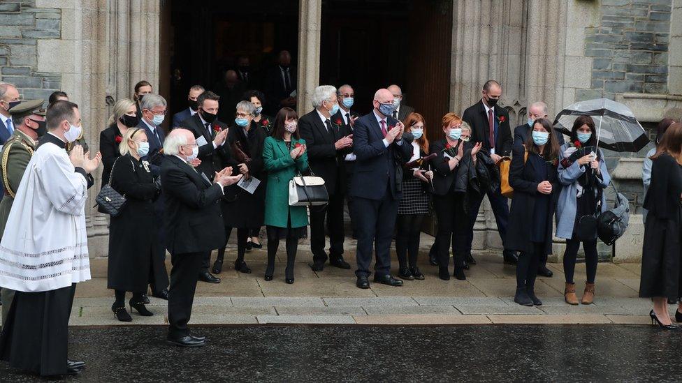 Mourners and politicians clapped as the funeral cortege left the cathedral.