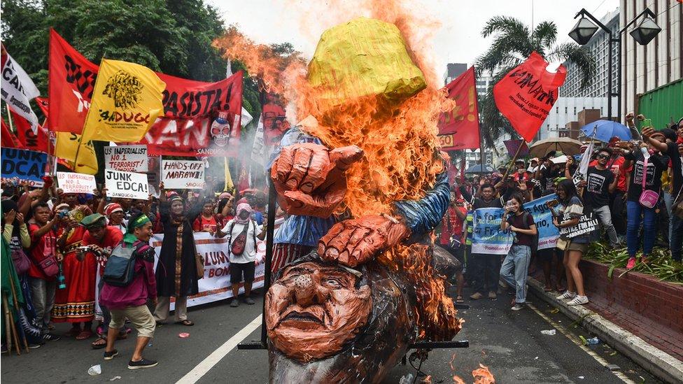 Anti-US protesters burn effigies of President Donald Trump and Philippine President Rodrigo Duterte during a rally in Manila in September 2017