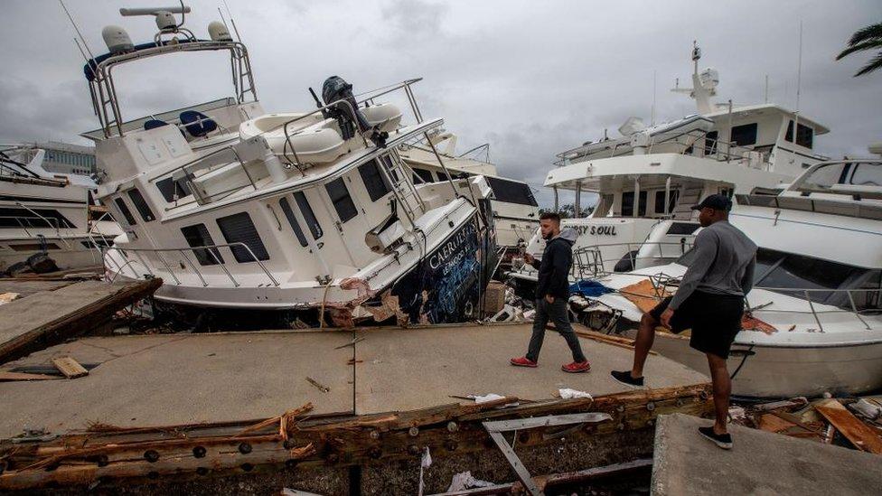 Boats destroyed from Hurricane Ian swept onto the causeway.