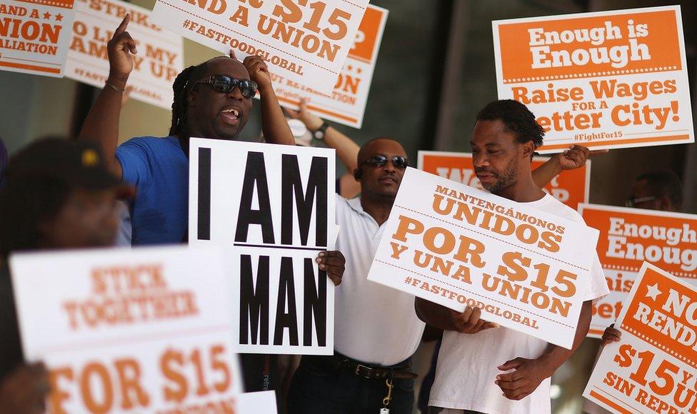 Protesters in support of a $15 an hour minimum wage stand together on September 10, 2015 in Fort Lauderdale, Florida.