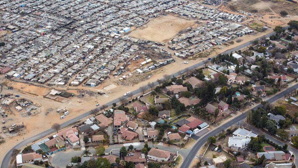 Squatter camp Kya Sands, home to South Africans and many African Immigrants in Johannesburg - across the road from middle class Bloubusrand nieghbourhood.