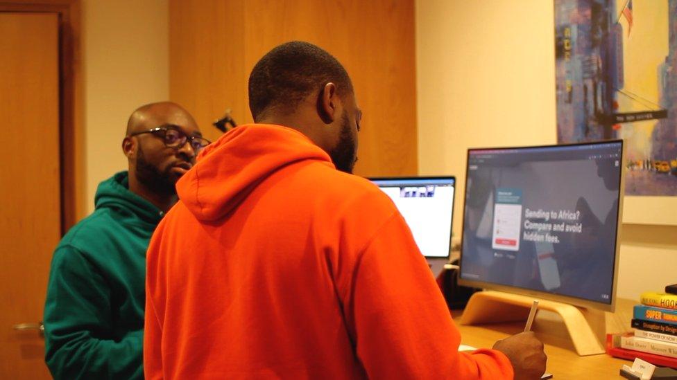 Two men in front of computer screens