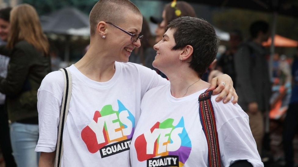 Tracy Clark and her partner Justyna Greinart embrace as they gather with a crowd of people to watch a large television screen at Federation Square as it is announced that same-sex marriage will be legal in Australia with Parliament agreeing to change the Marriage Act and end the ban on gay and lesbian couples marrying on December 7, 2017 in Melbourne, Australia