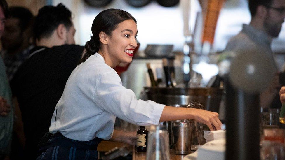 Rep. Alexandria Ocasio-Cortez works behind the bar at the Queensboro Restaurant