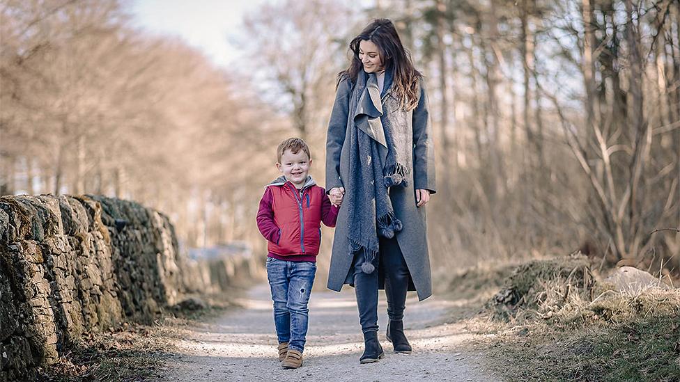 Kelly walking with her son Finnlay