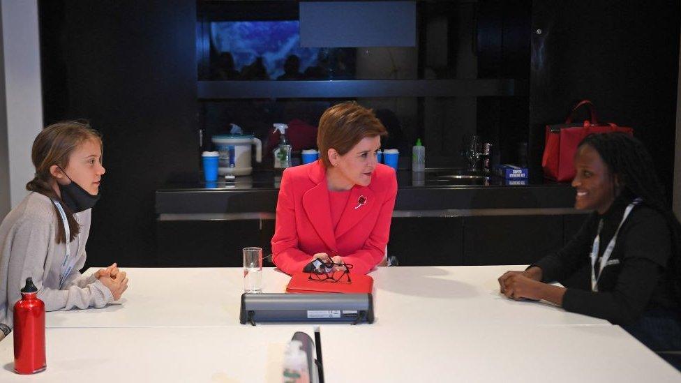 Greta Thunberg and Vanessa Nakate speaking to Scotland's First minister Nicola Sturgeon.