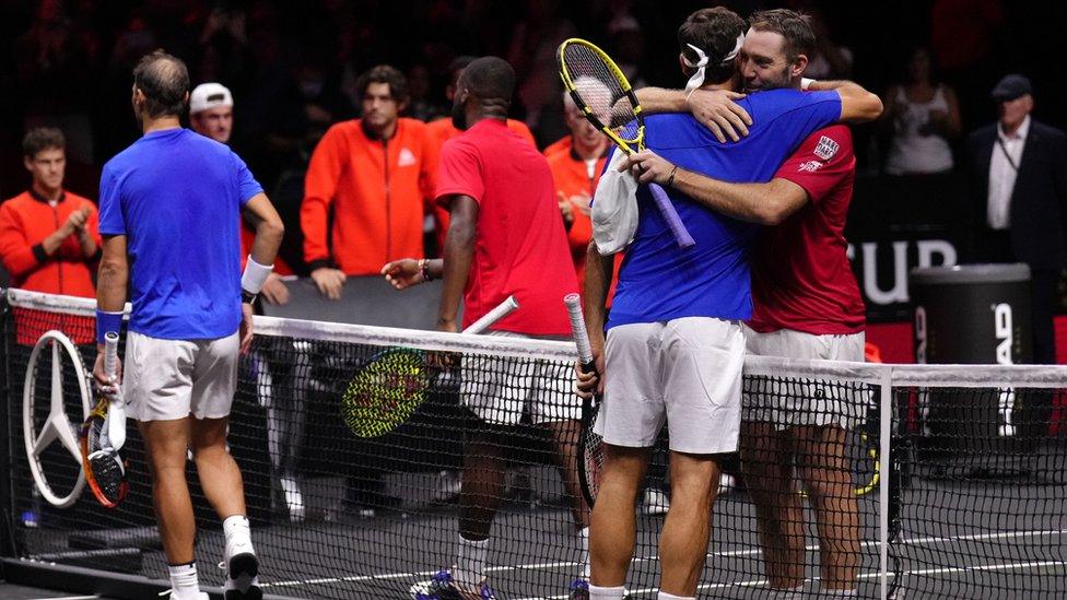 Roger Federer hugging another player