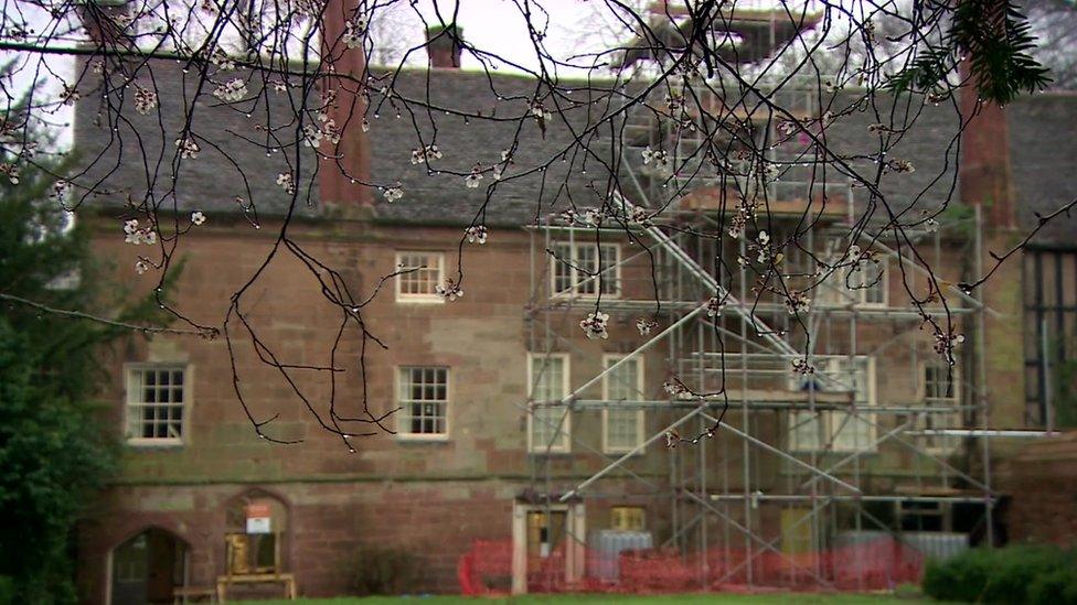 Charterhouse with scaffolding on walls