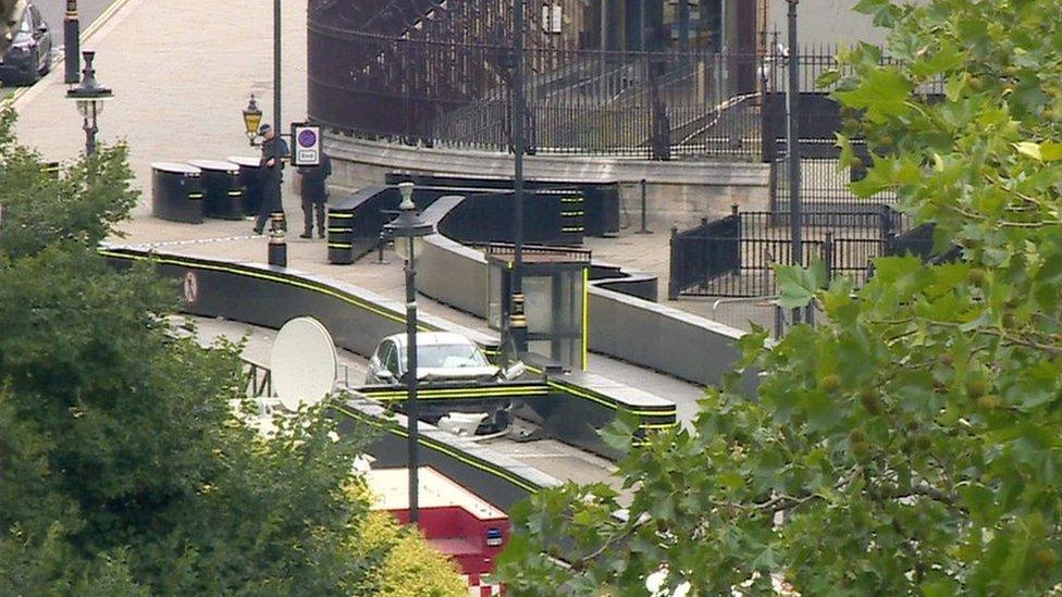 Still frame from BBC News footage of the car which crashed into security barriers outside the Houses of Parliament.