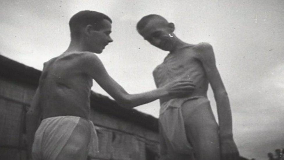 Two starving prisoners of war in loin cloths