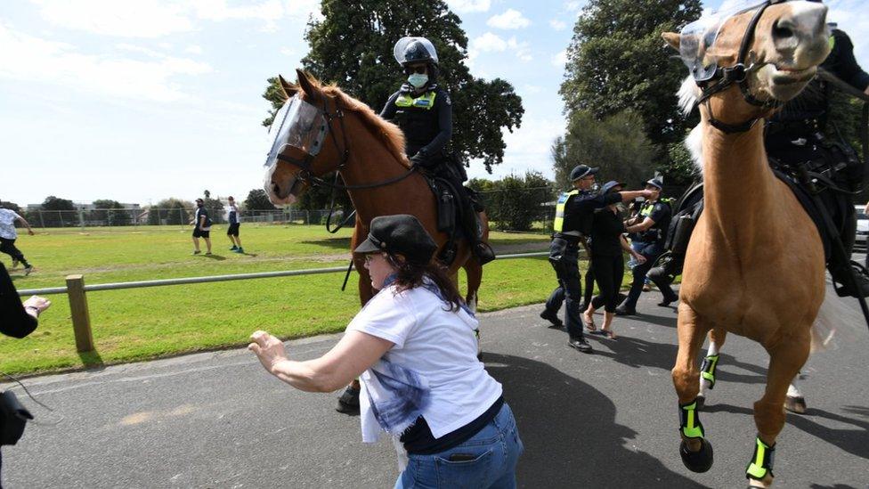 Police try to intercept protesters during an anti-lockdown protest in Melbourne, Australia, 19 September 2020