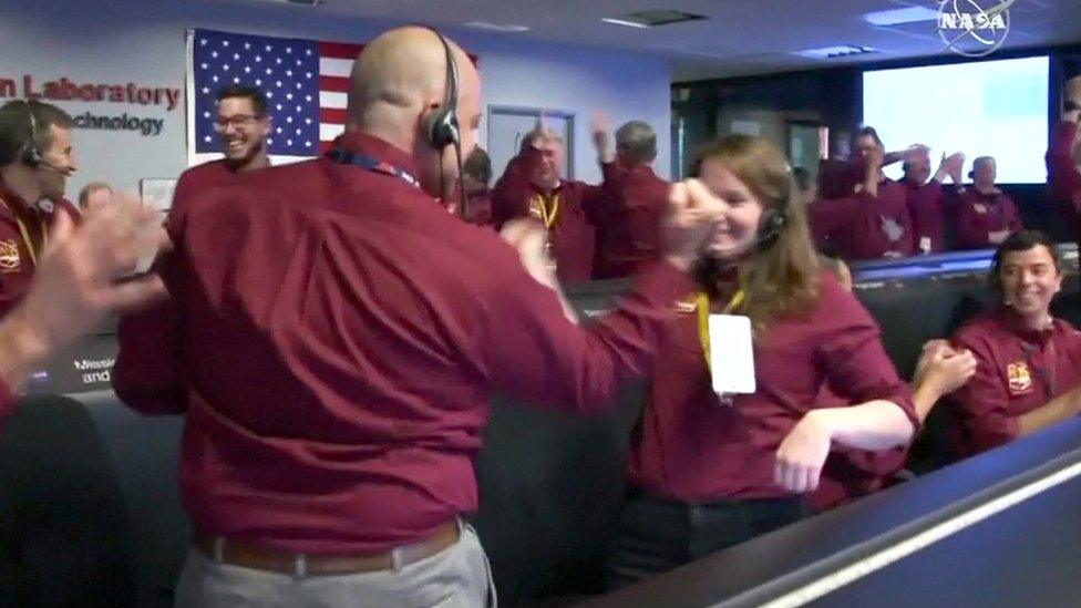 Nasa scientists do their handshake.