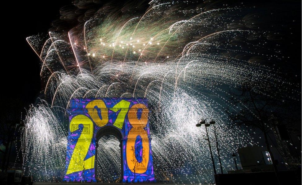 Fireworks light the sky over the Arc de Triomphe on the Champs-Élysées Avenue in Paris, 1 January 2018