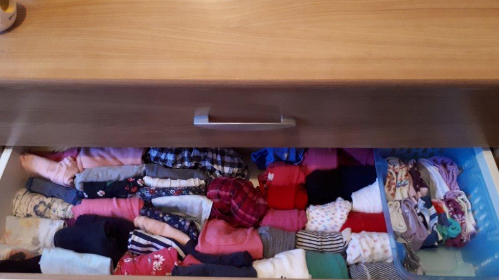 A draw of clothes folded in the Marie Kondo style