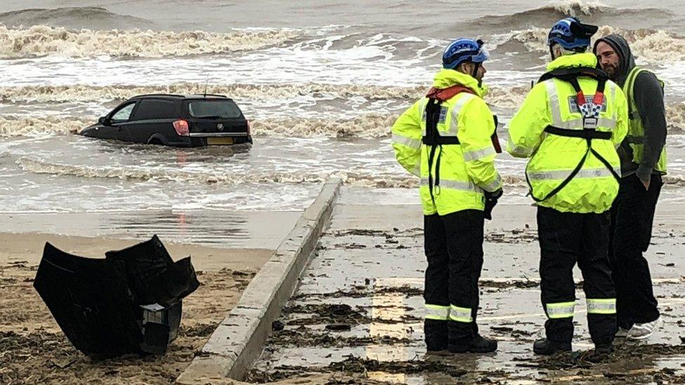 Coastguards on the beach by the stranded vehicle at Blackpool