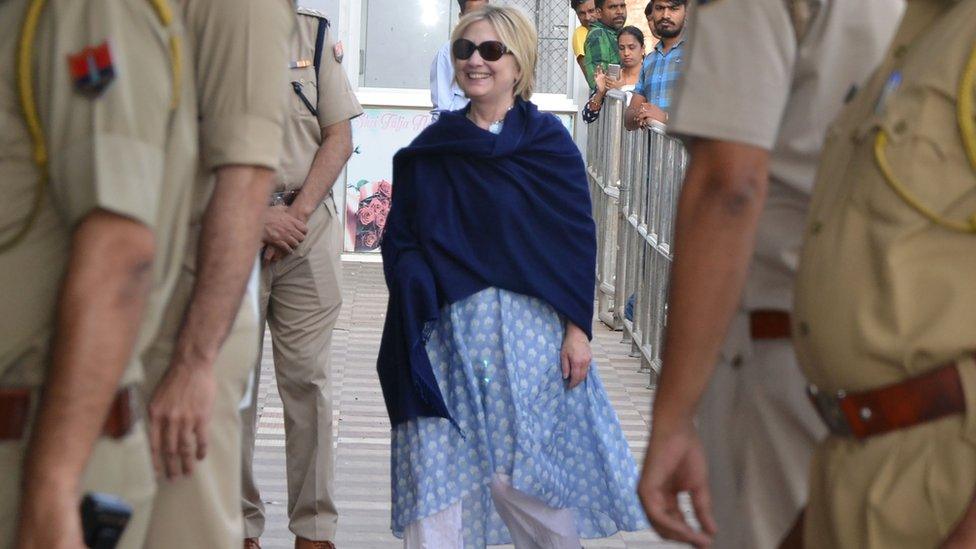 Photo taken on March 15, 2018 shows former US secretary of state Hillary Clinton, with her right hand covered under a shawl, at the airport as she leaves Jodhpur