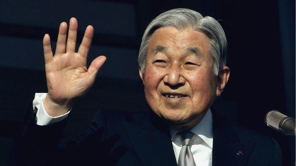 Japanese Emperor Akihito waves to well-wishers during his new year speech on the balcony of the Imperial Palace in Tokyo on 2 January 2017.