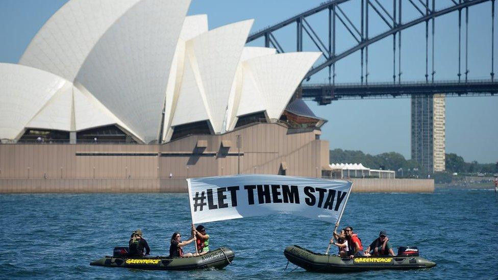 Members of Greenpeace protested in front of Sydney's Opera House as part of the #LETTHEMSTAY movement