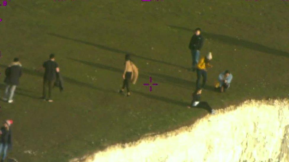 People near the edge of the cliffs at Beachy Head