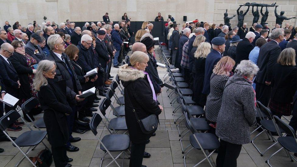 Veterans and the public observe a two minute silence during an Armistice Day service at the Armed Forces Memorial in the National Memorial Arboretum