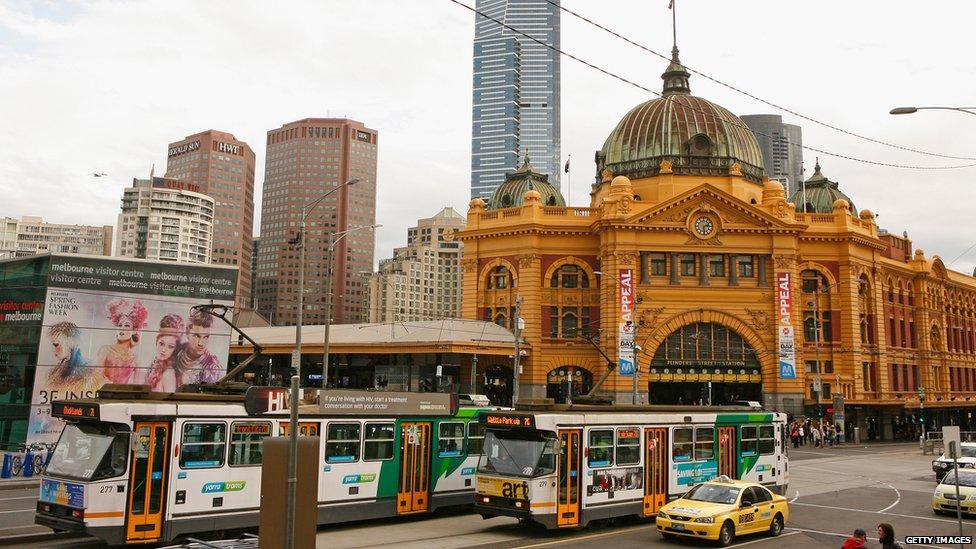 Trams go past Flinders Street Train station in Melbourne's CBD