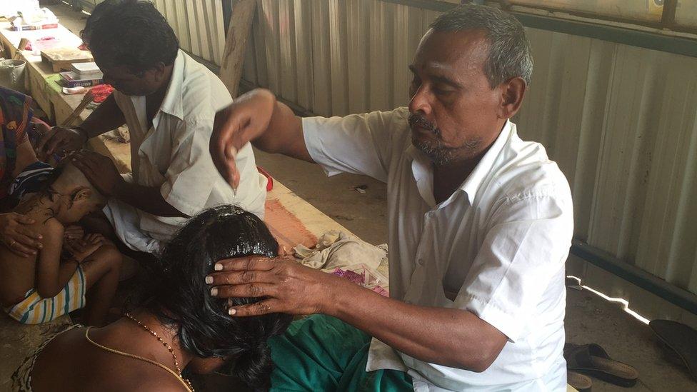 Men shaving people's heads