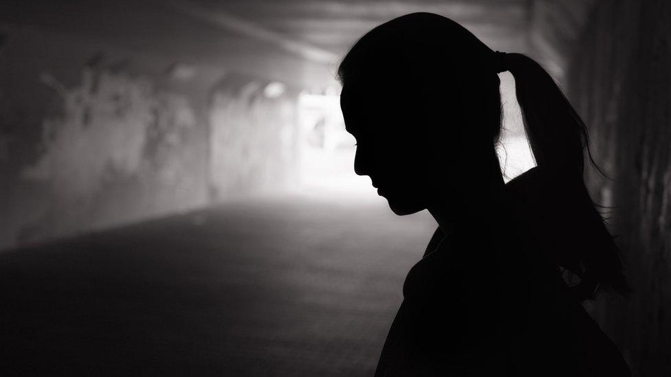 A depressed woman in a tunnel