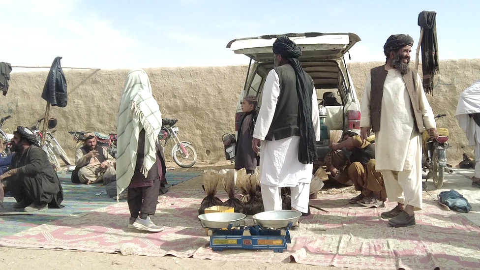 Scales and bags of opium can be seen at a market in Kandahar, Afghanistan